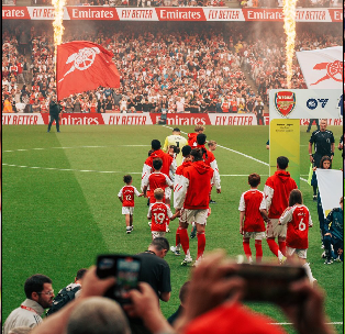 Arsenal squad on the pitch 
